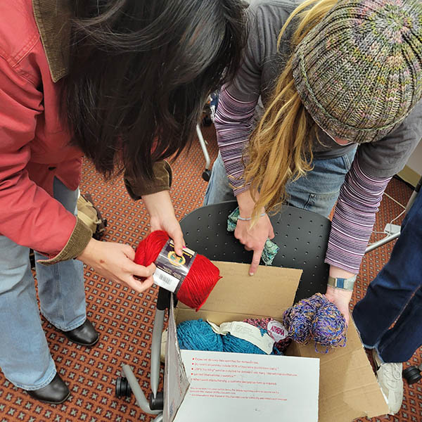 Students opening boxes of yarn at the Makerspace